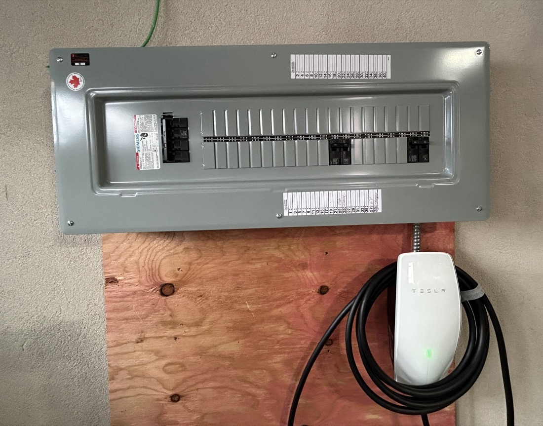 Residential electrical panel with Tesla EV charger installation